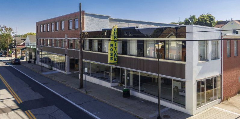 THE LOCAL GROUP, OF LILA DELMAN COMPASS, SELLS ICONIC  ROSE FURNITURE BUILDING IN EAST PROVIDENCE